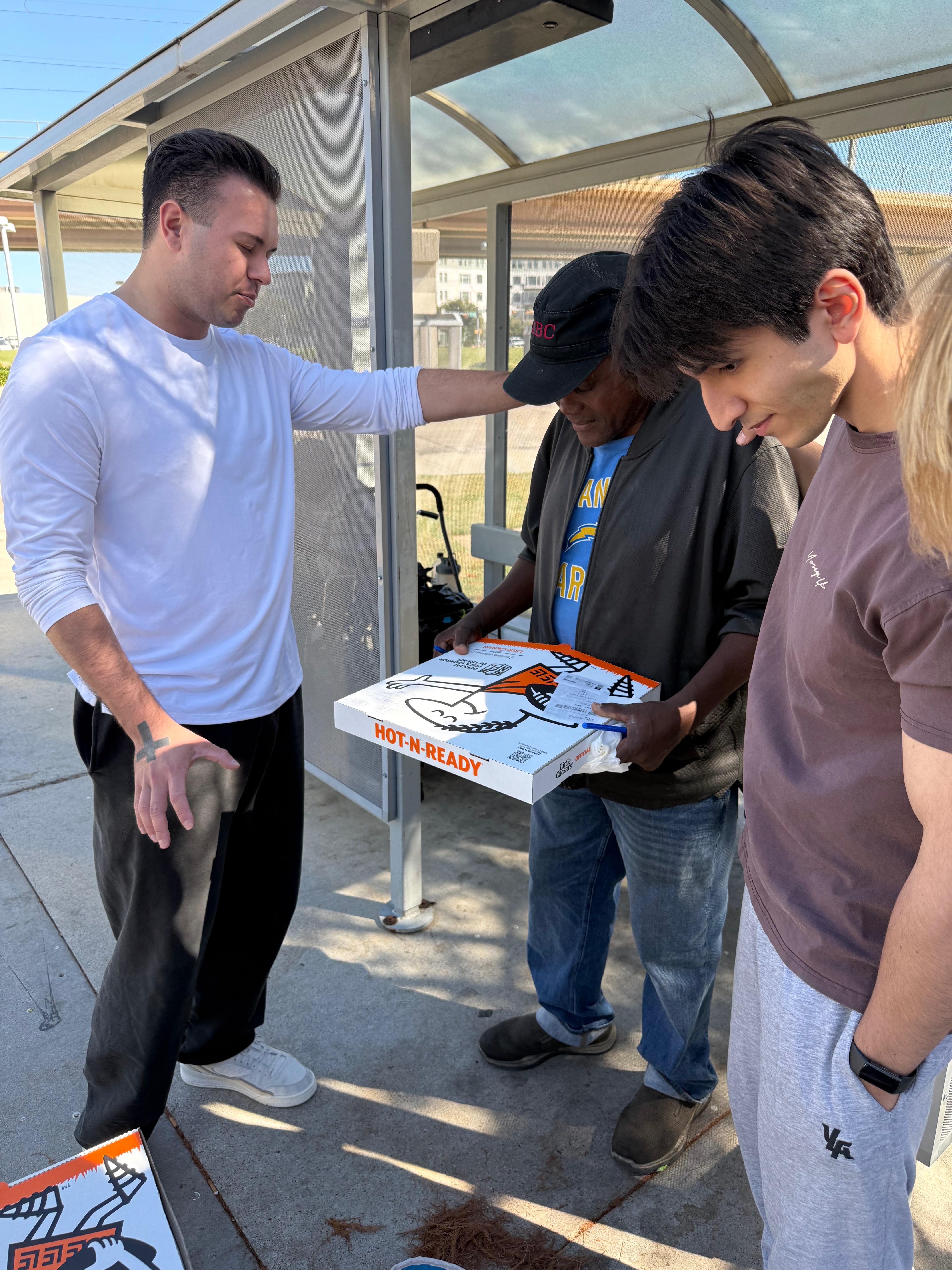 The Walk team serving and praying with homeless community in Dallas